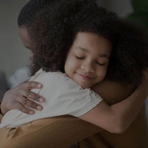 Child hugging his father