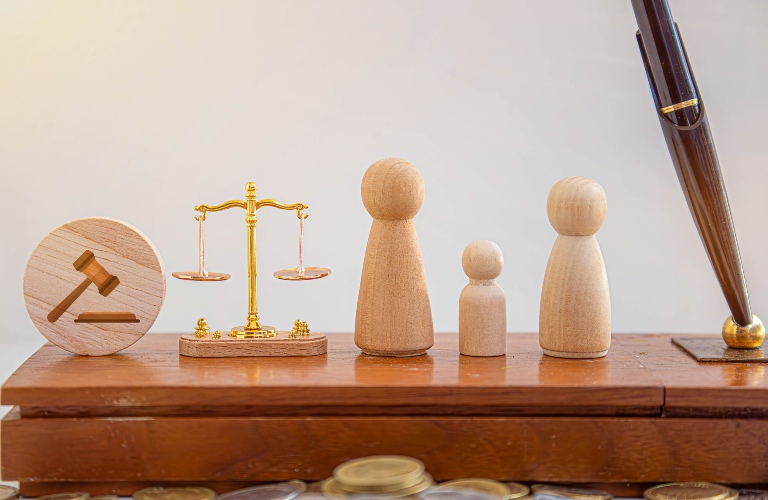 scales of justice and wooden model of family