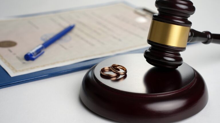 Judge gavel with wedding rings