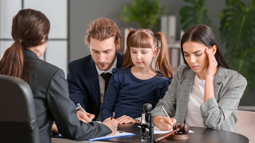 Young couple and their daughter visiting divorce lawyer