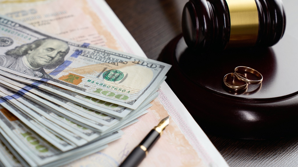 Wedding rings, judge gavel, US dollar bills