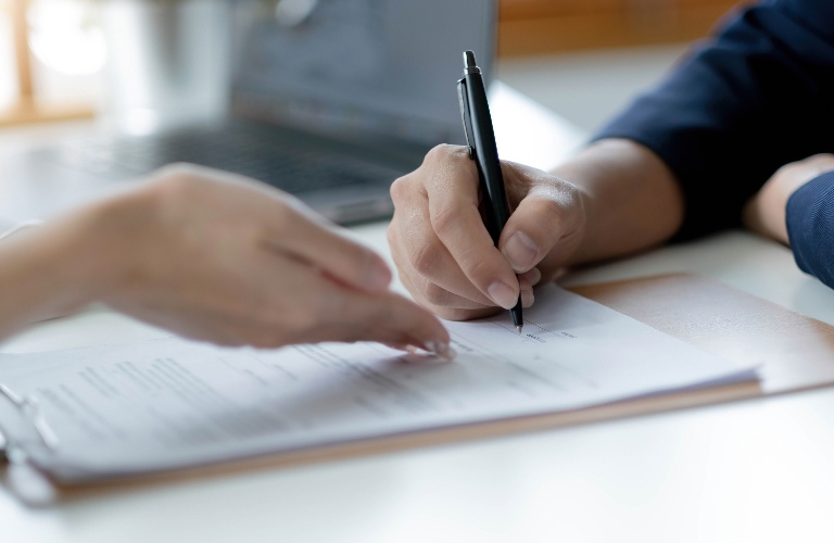 Lawyer is showing client where to sign document