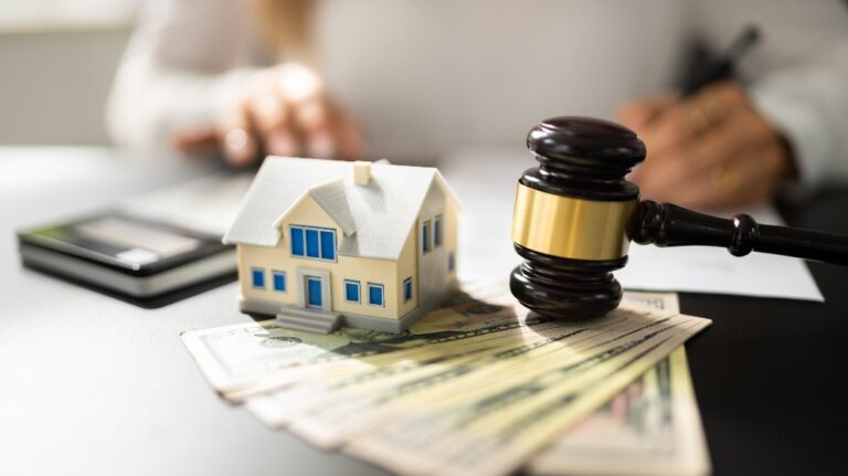 gavel with a house and money